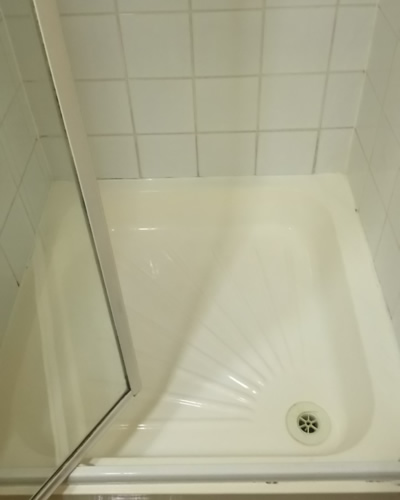 The same shower tray and tiles clean and bright after deep cleaning