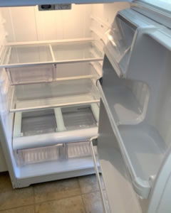 The same fridge interior spotless after a full fridge clean